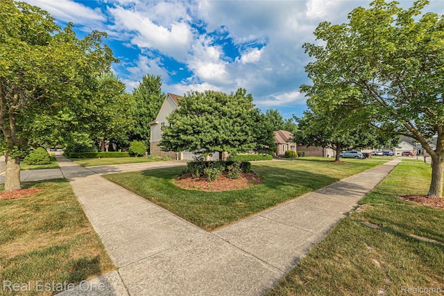 51992 Boland Rd, Chesterfield, MI 48047 - view of community with a lawn, concrete driveway, and a garage