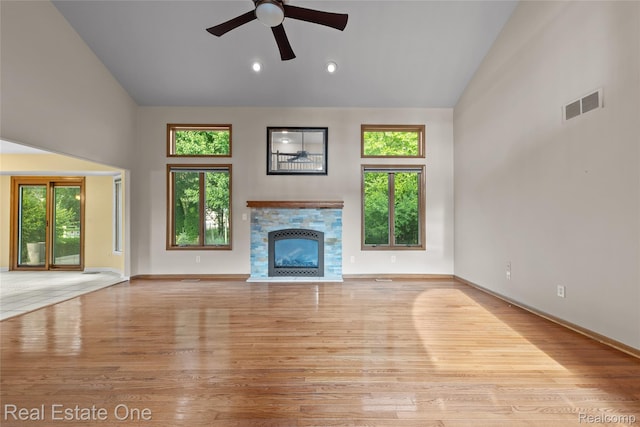 51992 Boland Rd, Chesterfield, MI 48047 - unfurnished living room featuring high vaulted ceiling, wood finished floors, a glass covered fireplace, and a ceiling fan