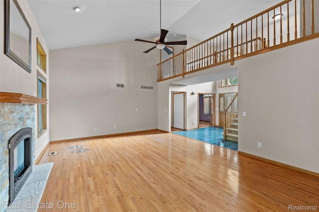 51992 Boland Rd, Chesterfield, MI 48047 - unfurnished living room with high vaulted ceiling, a fireplace, ceiling fan, stairs, and wood finished floors