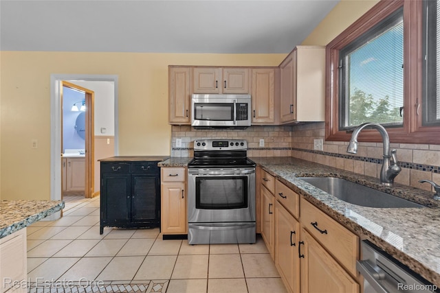 51992 Boland Rd, Chesterfield, MI 48047 - kitchen with stainless steel appliances, backsplash, stone counters, and light brown cabinets