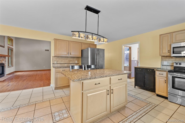 51992 Boland Rd, Chesterfield, MI 48047 - kitchen with stainless steel appliances, light tile patterned floors, light brown cabinets, and tasteful backsplash