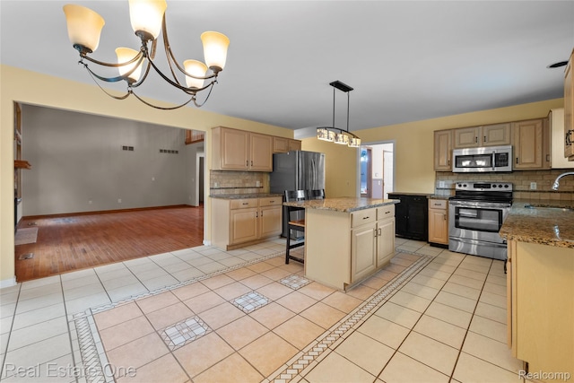 51992 Boland Rd, Chesterfield, MI 48047 - kitchen featuring stainless steel appliances, a chandelier, light tile patterned flooring, decorative backsplash, and a center island