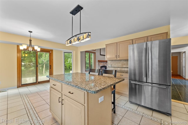51992 Boland Rd, Chesterfield, MI 48047 - kitchen featuring freestanding refrigerator, light tile patterned flooring, a center island, and a chandelier