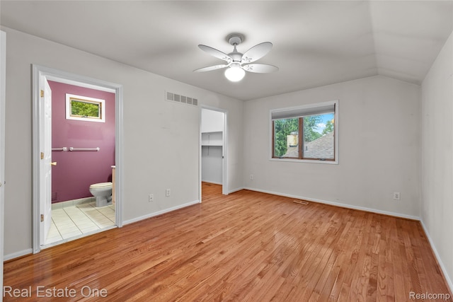 51992 Boland Rd, Chesterfield, MI 48047 - unfurnished bedroom featuring light wood-style floors, a spacious closet, ensuite bathroom, and a closet