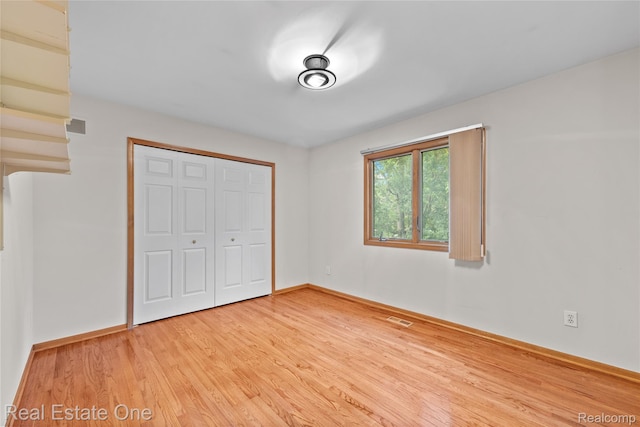 51992 Boland Rd, Chesterfield, MI 48047 - unfurnished bedroom featuring light wood-style flooring and a closet