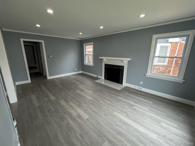 4651 Berkshire St, Detroit, MI 48224 - unfurnished living room featuring crown molding, recessed lighting, wood finished floors, and a high end fireplace