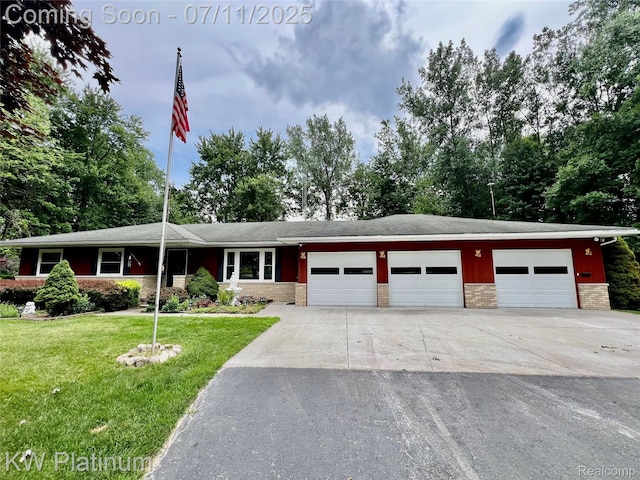 3775 Carrigan Rd, Fort Gratiot, MI 48059 - view of front of home featuring an attached garage, driveway, brick siding, and a front yard