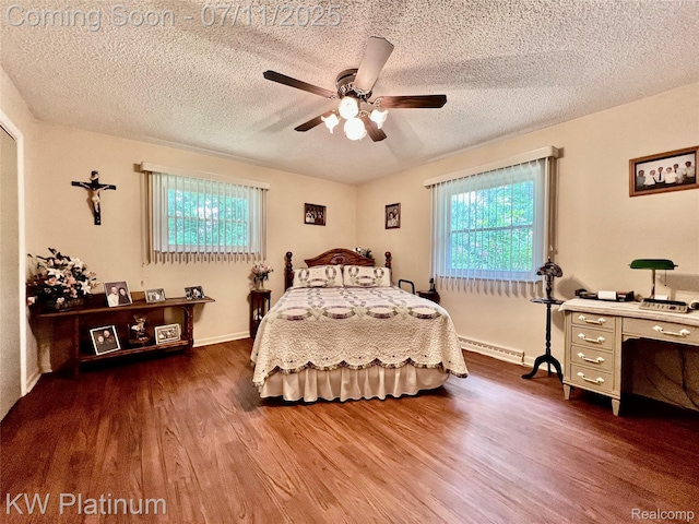 3775 Carrigan Rd, Fort Gratiot, MI 48059 - bedroom featuring dark wood-style floors, a baseboard radiator, a textured ceiling, and a ceiling fan