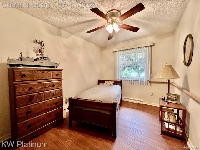 3775 Carrigan Rd, Fort Gratiot, MI 48059 - bedroom featuring a baseboard heating unit, a textured ceiling, dark wood-style floors, and a ceiling fan