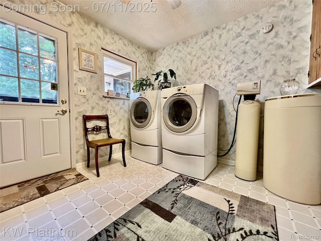3775 Carrigan Rd, Fort Gratiot, MI 48059 - washroom with washer and clothes dryer, a textured ceiling, wallpapered walls, and light tile patterned floors