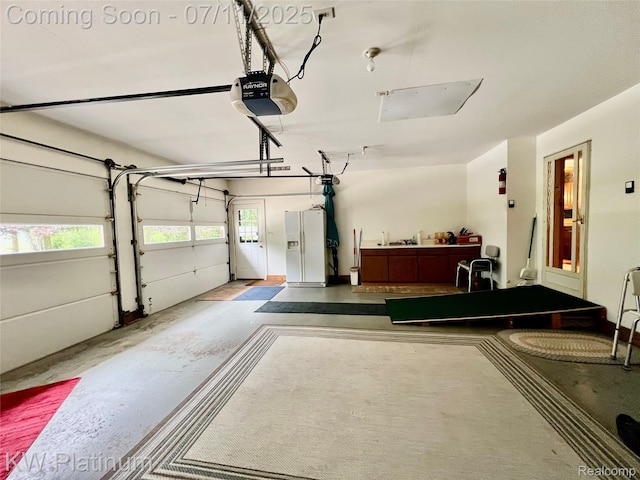 3775 Carrigan Rd, Fort Gratiot, MI 48059 - garage featuring white fridge with ice dispenser and a garage door opener