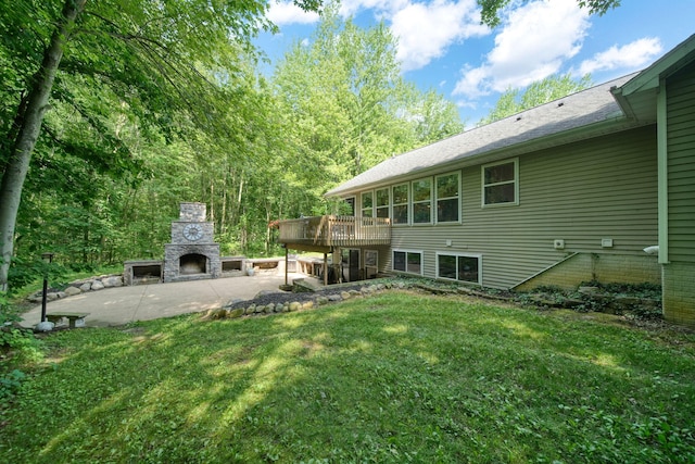 8395 Dalton Rd, Onsted, MI 49265 - view of green lawn featuring an outdoor stone fireplace, a patio area, and a wooden deck