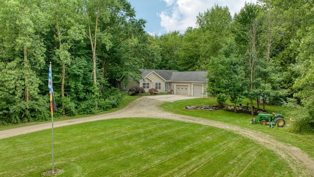 8395 Dalton Rd, Onsted, MI 49265 - view of front of house featuring dirt driveway, a garage, a front lawn, and a forest view