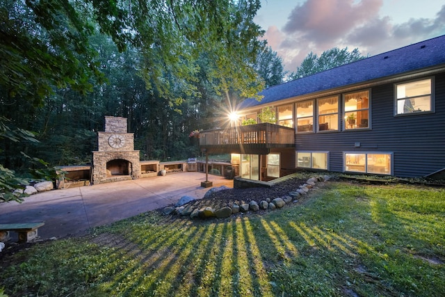 8395 Dalton Rd, Onsted, MI 49265 - view of grassy yard with an outdoor stone fireplace, a patio area, a deck, and driveway