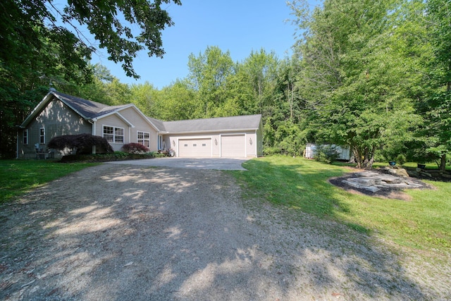 8395 Dalton Rd, Onsted, MI 49265 - ranch-style home featuring asphalt driveway, a garage, and a front lawn