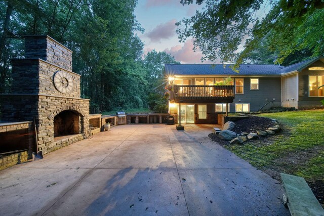 8395 Dalton Rd, Onsted, MI 49265 - view of front of property featuring an outdoor brick fireplace, concrete driveway, a deck, stone siding, and a chimney