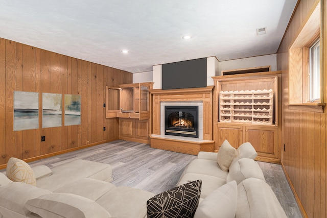 2240 Quincy Ave, Portage, MI 49024 - living room featuring wooden walls, wood finished floors, a glass covered fireplace, and recessed lighting