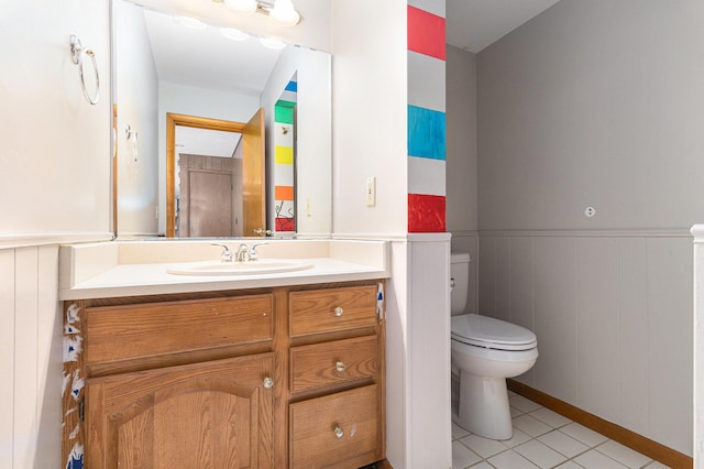 2240 Quincy Ave, Portage, MI 49024 - bathroom featuring vanity, wainscoting, tile patterned flooring, and a decorative wall