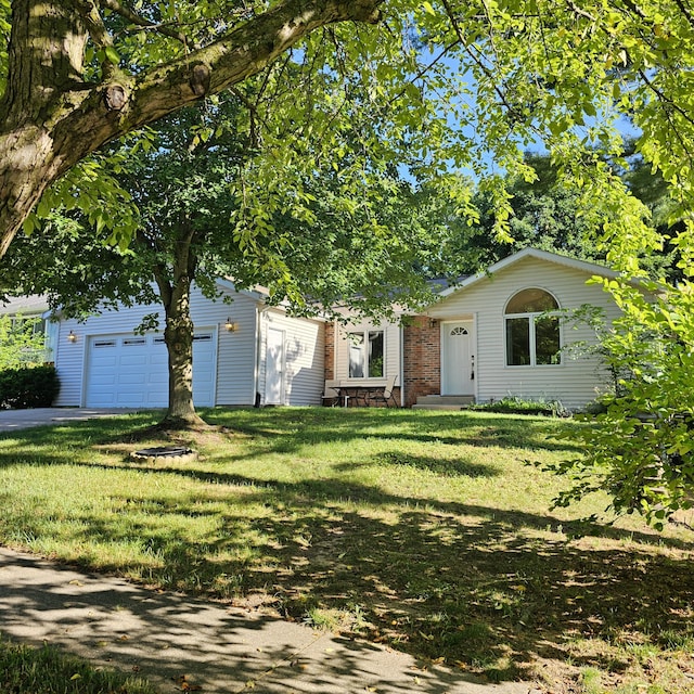 2240 Quincy Ave, Portage, MI 49024 - view of property hidden behind natural elements featuring a garage and a front lawn