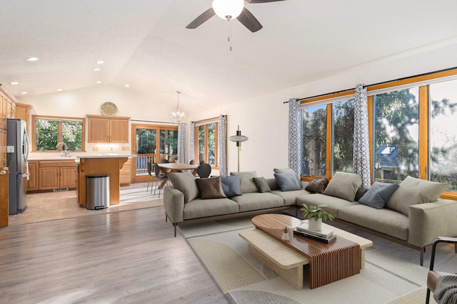 2240 Quincy Ave, Portage, MI 49024 - living area featuring vaulted ceiling, a chandelier, light wood-style floors, a ceiling fan, and recessed lighting