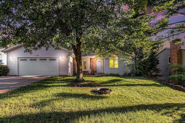 2240 Quincy Ave, Portage, MI 49024 - view of front facade with concrete driveway, an attached garage, and a front lawn