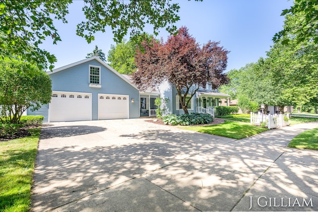 1214 Euna Vista Dr, Holland, MI 49423 - view of front facade featuring concrete driveway, a porch, a front yard, and a garage