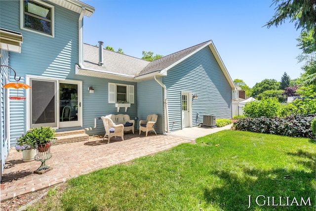 1214 Euna Vista Dr, Holland, MI 49423 - back of property with a yard, a patio area, entry steps, a shingled roof, and an outdoor hangout area