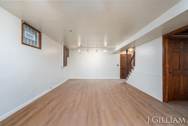 1214 Euna Vista Dr, Holland, MI 49423 - finished basement with rail lighting, light wood-style floors, and stairway