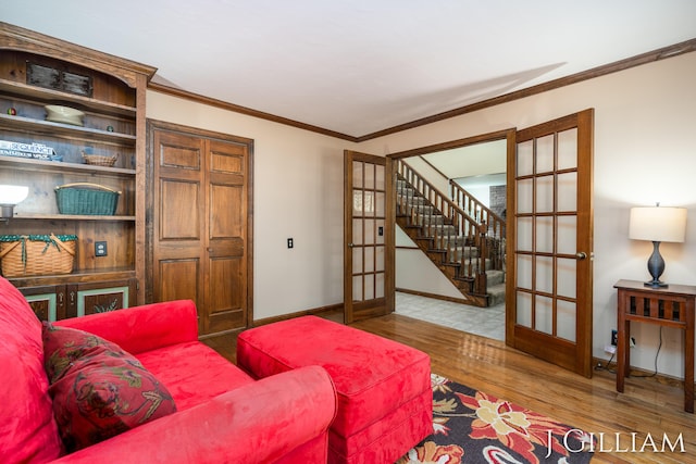 1214 Euna Vista Dr, Holland, MI 49423 - living area featuring french doors, wood finished floors, ornamental molding, and stairs