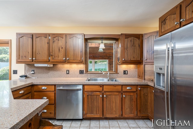 1214 Euna Vista Dr, Holland, MI 49423 - kitchen with appliances with stainless steel finishes, decorative backsplash, and brown cabinets
