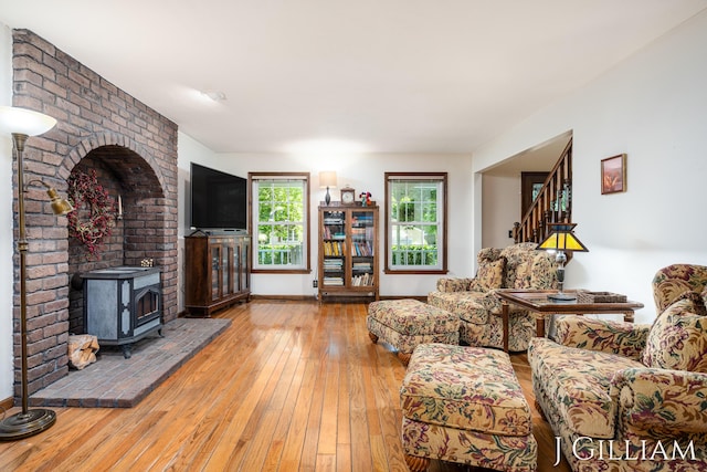 1214 Euna Vista Dr, Holland, MI 49423 - living area with a wood stove, hardwood / wood-style flooring, and stairs