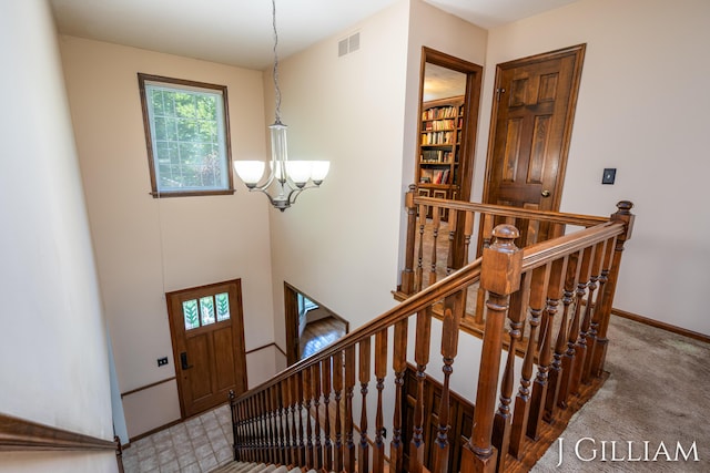 1214 Euna Vista Dr, Holland, MI 49423 - stairs featuring carpet floors and a chandelier