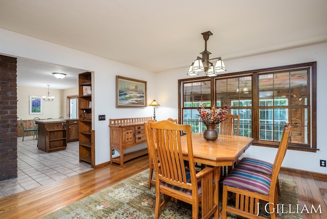 1214 Euna Vista Dr, Holland, MI 49423 - dining space featuring a chandelier and light wood-style floors