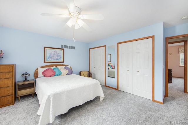 32851 Foster Ct, Fraser, MI 48026 - carpeted bedroom with two closets and a ceiling fan
