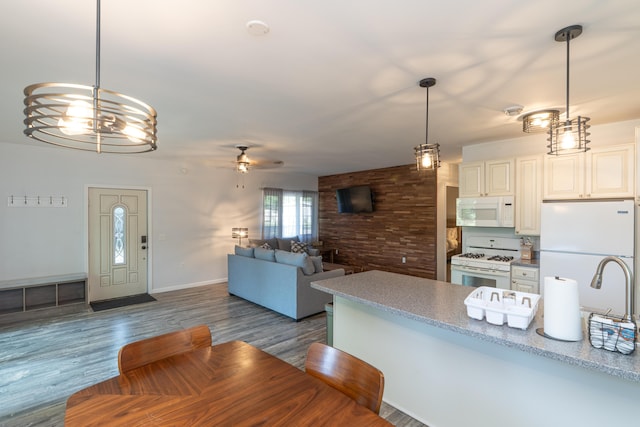 11901 187th Ave, Stanwood, MI 49346 - kitchen featuring white appliances, dark wood-style floors, a ceiling fan, pendant lighting, and open floor plan