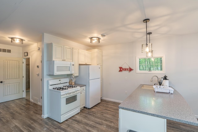 11901 187th Ave, Stanwood, MI 49346 - kitchen featuring white appliances, dark wood finished floors, a peninsula, and pendant lighting
