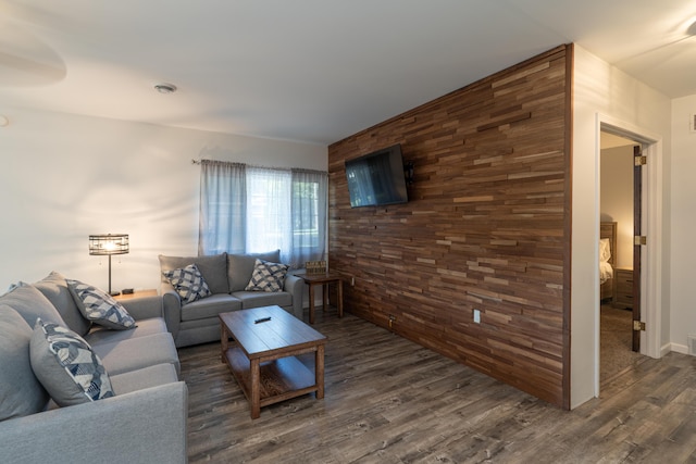 11901 187th Ave, Stanwood, MI 49346 - living area featuring dark wood finished floors, wood walls, and an accent wall