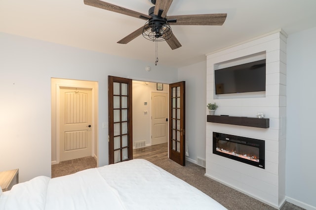 11901 187th Ave, Stanwood, MI 49346 - carpeted bedroom featuring a large fireplace, french doors, and ceiling fan