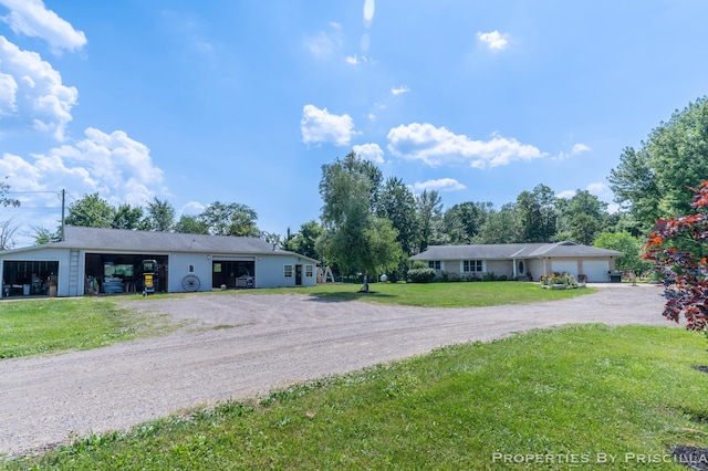 9265 Mulliken Rd, Mulliken, MI 48861 - ranch-style home featuring driveway, a front lawn, and a garage