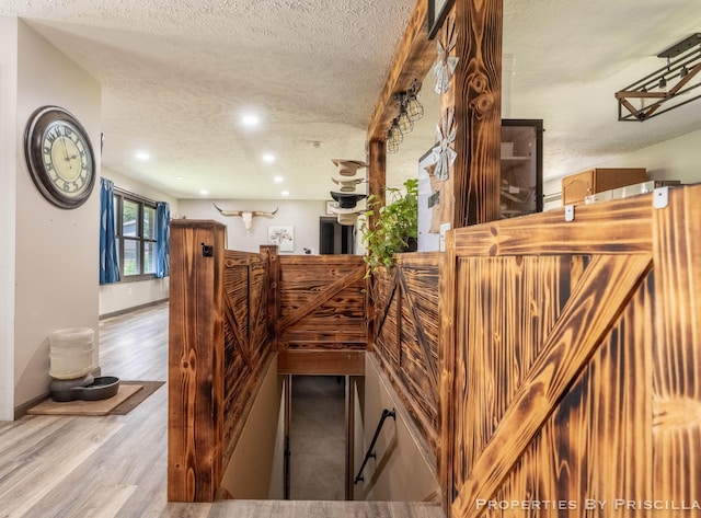 9265 Mulliken Rd, Mulliken, MI 48861 - stairs with a textured ceiling, wood finished floors, and recessed lighting