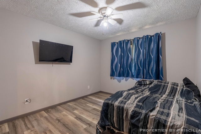 9265 Mulliken Rd, Mulliken, MI 48861 - bedroom with wood finished floors, a textured ceiling, and ceiling fan