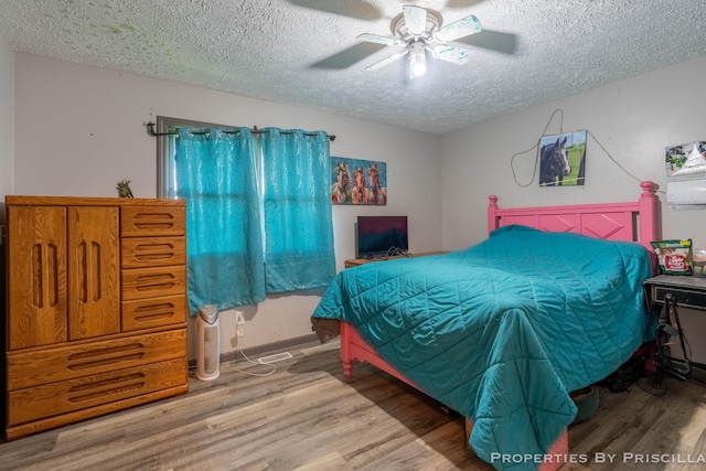 9265 Mulliken Rd, Mulliken, MI 48861 - bedroom with wood finished floors, a textured ceiling, and a ceiling fan