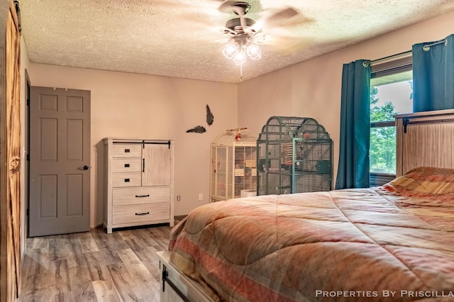 9265 Mulliken Rd, Mulliken, MI 48861 - bedroom featuring wood finished floors, a textured ceiling, and ceiling fan