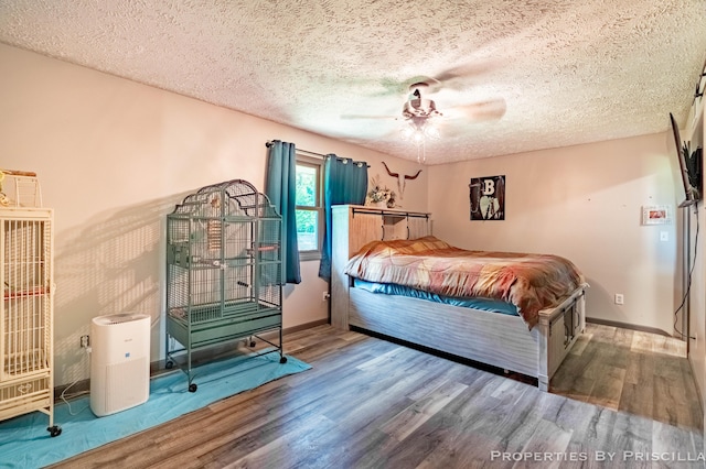 9265 Mulliken Rd, Mulliken, MI 48861 - bedroom with wood finished floors, a textured ceiling, and a ceiling fan