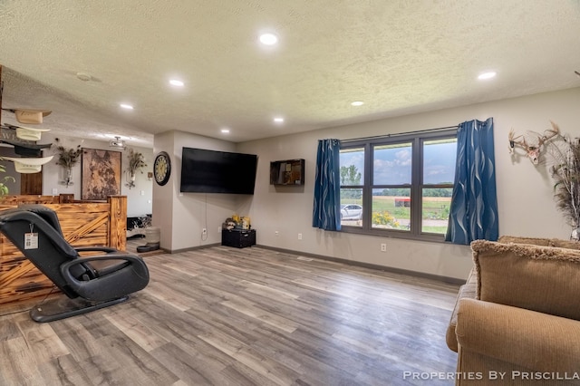 9265 Mulliken Rd, Mulliken, MI 48861 - living area with recessed lighting, wood finished floors, and a textured ceiling