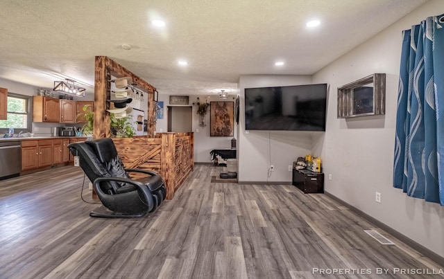 9265 Mulliken Rd, Mulliken, MI 48861 - living room featuring wood finished floors, recessed lighting, and a textured ceiling