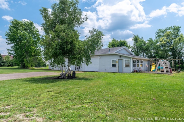 9265 Mulliken Rd, Mulliken, MI 48861 - view of green lawn featuring a playground and driveway