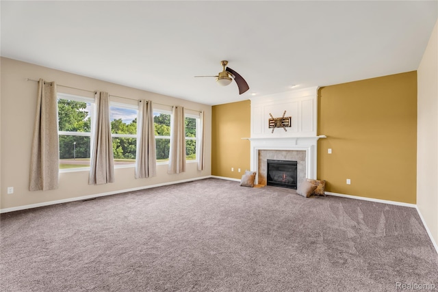6119 Amber Ln, Grand Blanc, MI 48439 - unfurnished living room with a ceiling fan, a tiled fireplace, plenty of natural light, and carpet