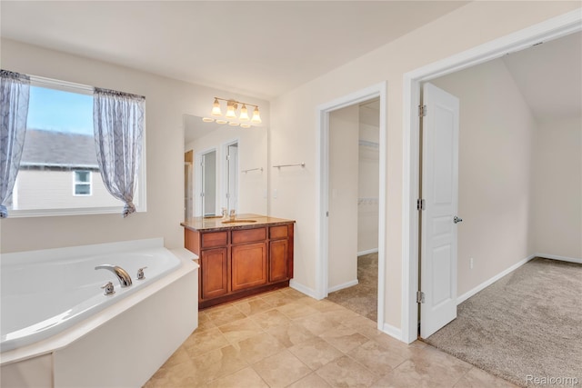 6119 Amber Ln, Grand Blanc, MI 48439 - full bathroom featuring vanity, a bath, a spacious closet, and a chandelier
