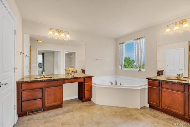 6119 Amber Ln, Grand Blanc, MI 48439 - bathroom featuring two vanities, a garden tub, and a chandelier